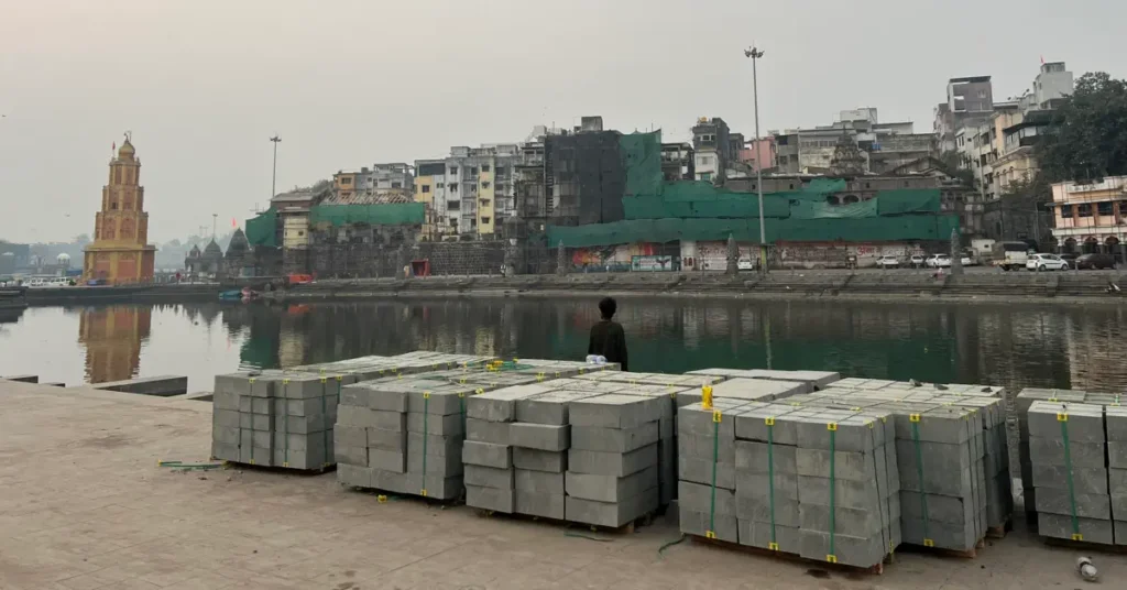 Current Construction Progress at Ram Kund Ghats Stacks of stone blocks on the banks of the Godavari river for the widening of the Ram Kund ghats in Nashik.
